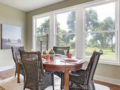 Dining room area with windows on the back wall